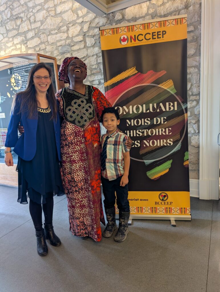 Guests posing with the NCCEEP Omoluabi Black History Month banner at Mackenzie Hall