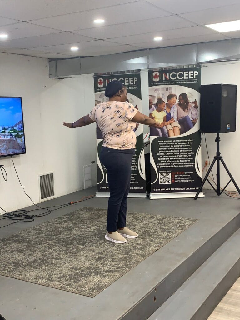 The session leader mid-movement on the rug, arms outstretched