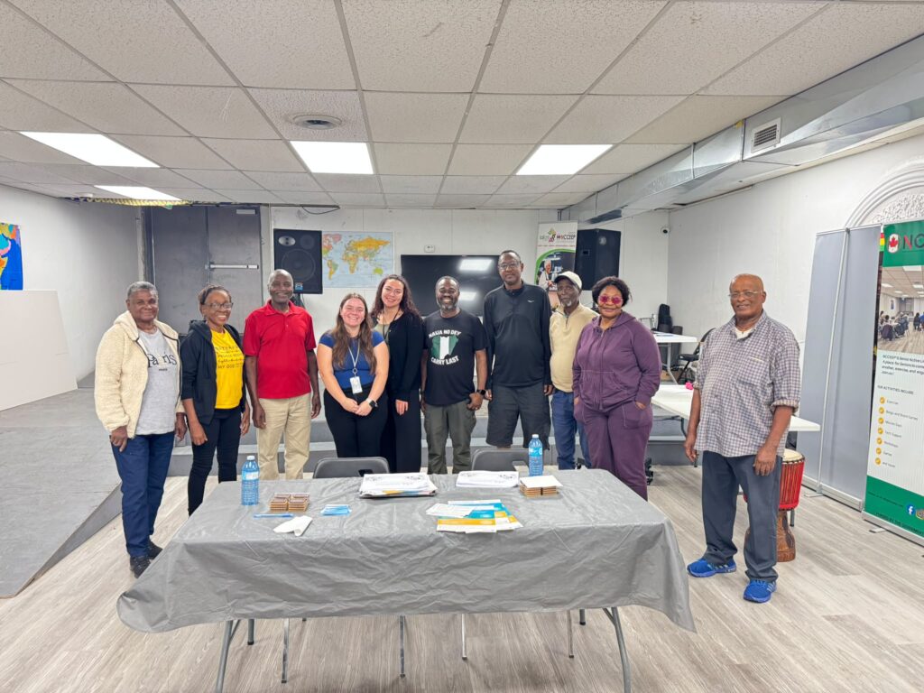 The group standing together behind the front table at the end of the talk, the two presenters among them
